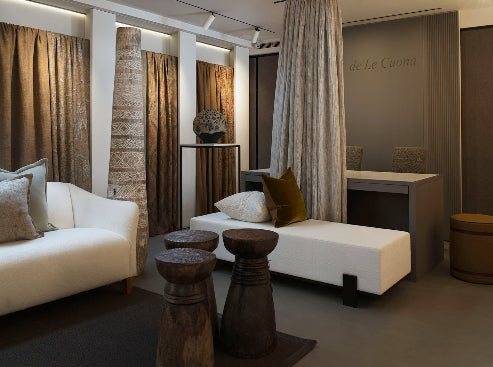 Modern interior design with a sofa, ottoman, and decorative elements.