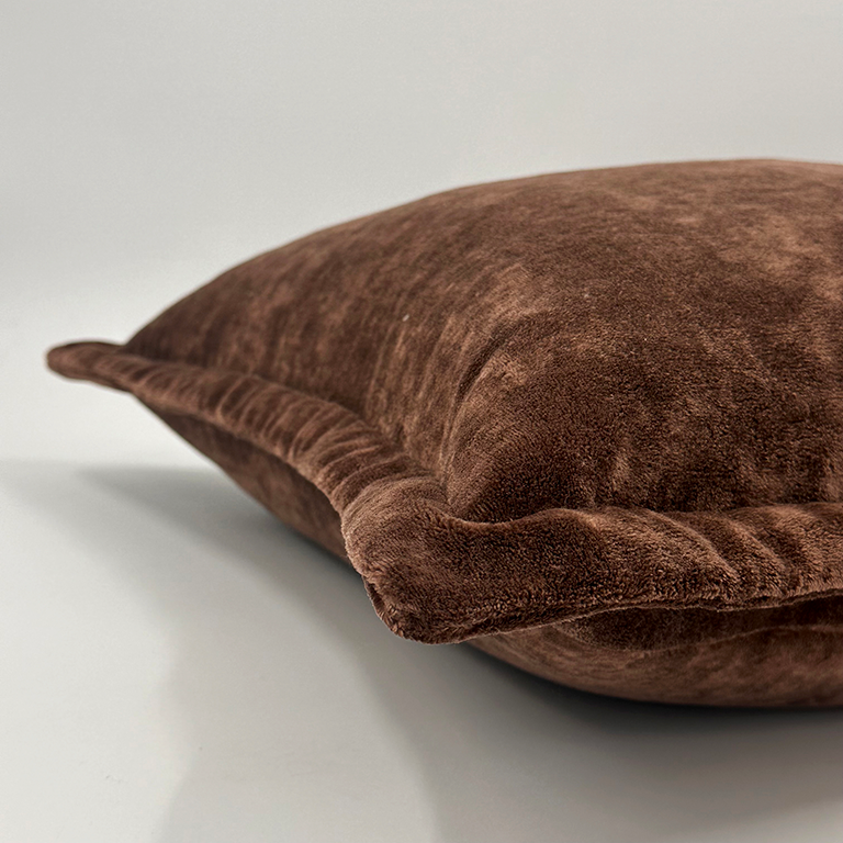 Brown cushion on a light grey background