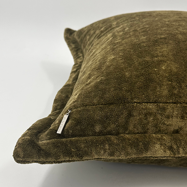 Brown textured cushion with a brand tag on a white background