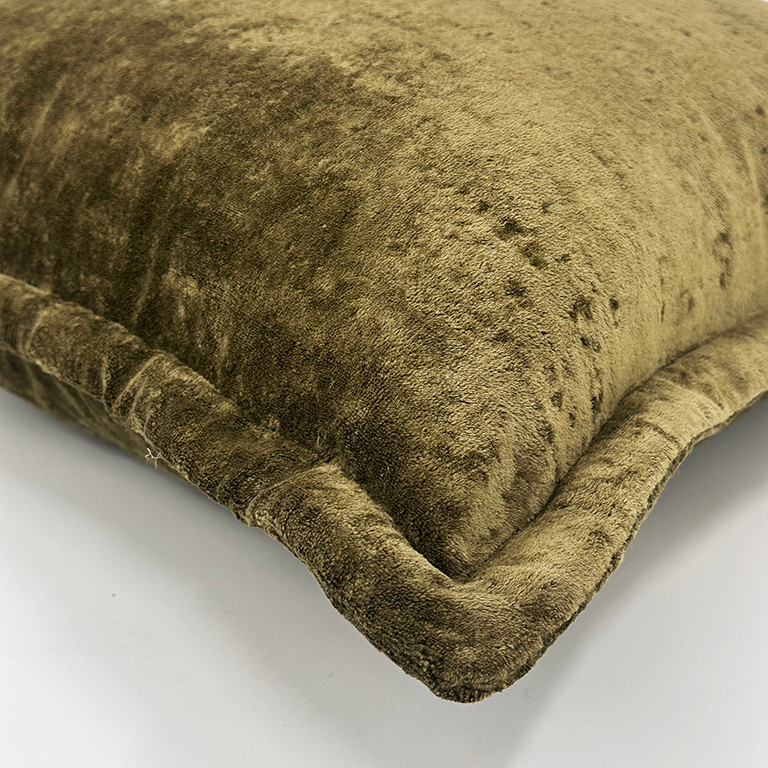 Close-up of a textured green cushion on a white background