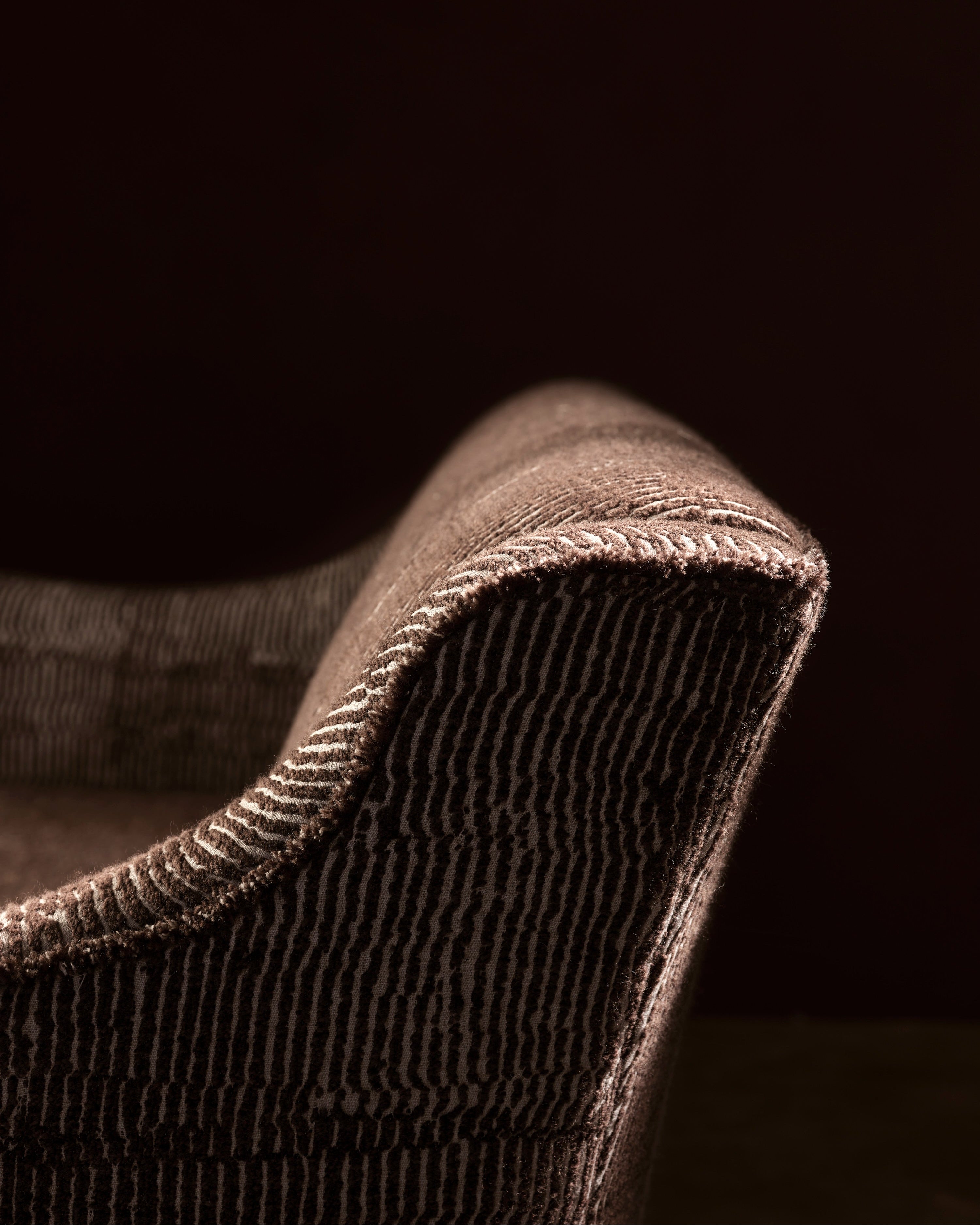 Close-up of a textured fabric edge with a dark background