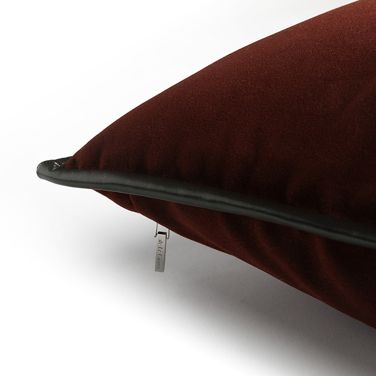 Brown cushion with a brand tag on a white background