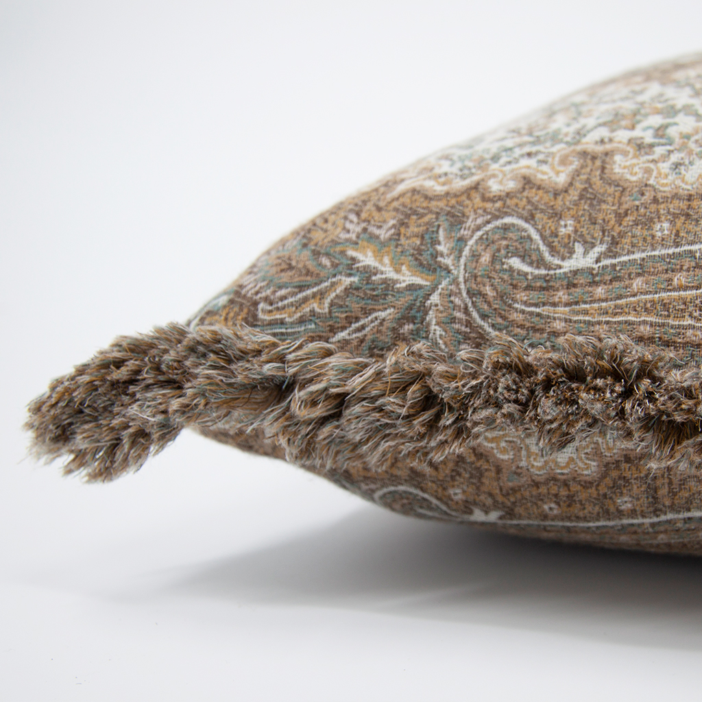 Close-up of a decorative cushion with intricate patterns on a white background