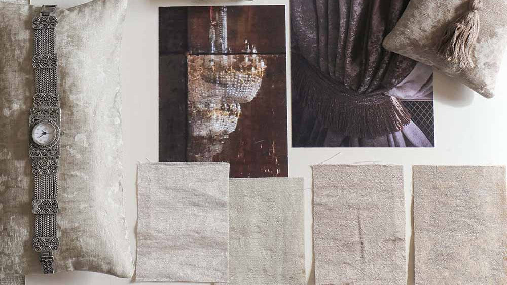 A styled interior design mood board featuring textured neutral-toned fabrics, two decorative pillows, fabric swatches, a vintage-style ornate wall clock, and two printed textile/curtain images labeled 'Palazzo' and 'Rialto' on a white background.